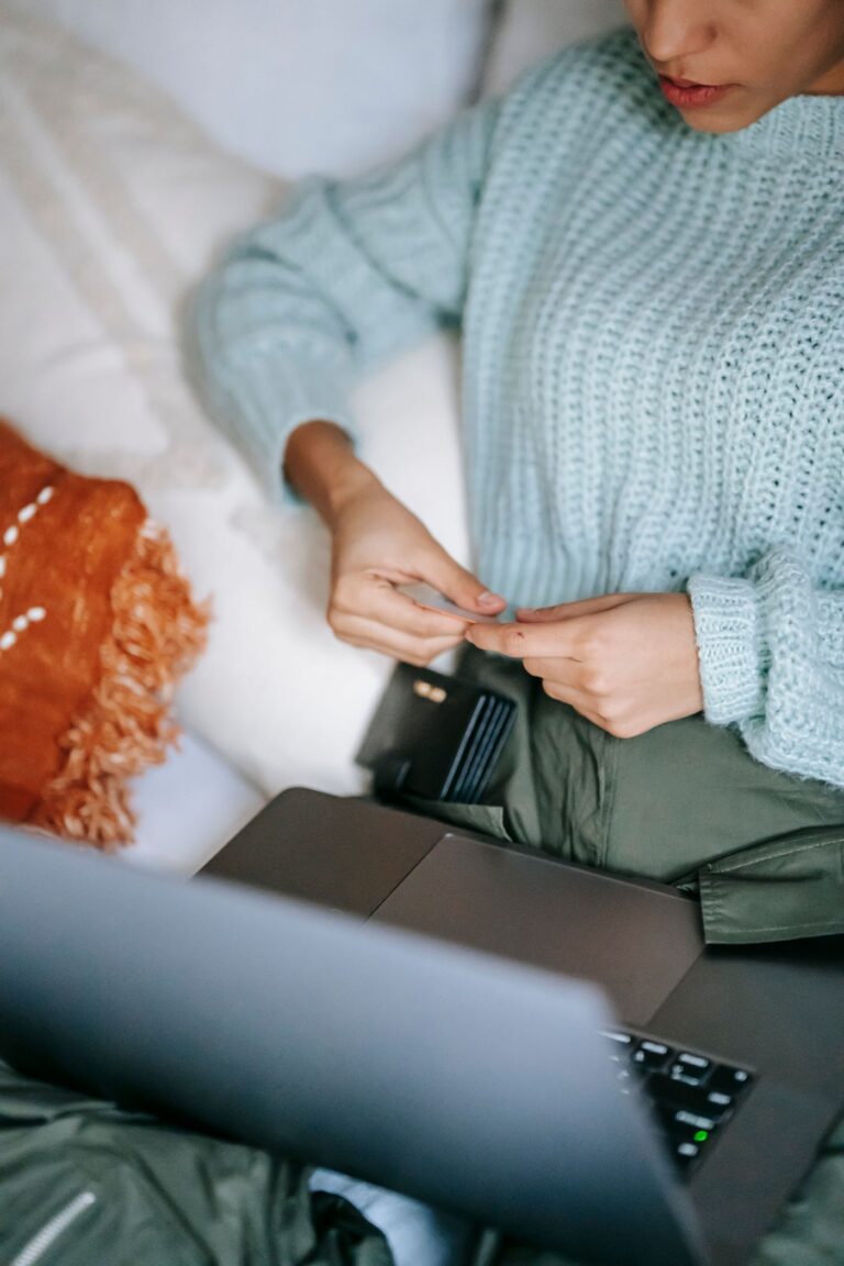 A shopper reviewing information on a laptop before buying
